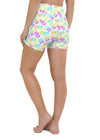 Relaxed back view of model wearing white yoga shorts with colorful heart design, showcasing fit