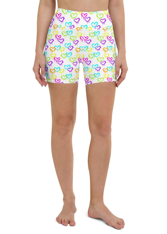 Full front view of white high-waisted yoga shorts featuring vibrant heart design