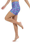 Model in motion wearing slate blue high-waisted yoga shorts with galaxy cat pattern