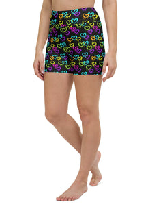  Front view of model wearing black high-waisted yoga shorts with melting heart print