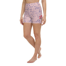  Front view of pink high-waisted yoga shorts with bold girl power icons and designs.
