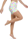 Model in motion wearing white yoga shorts with colorful heart design, showcasing fit