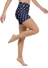 Model in motion wearing neon heart yoga shorts with high-waisted fit, highlighting flexibility