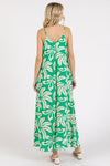 The back view highlights the flowy silhouette of the kelly green printed v-neck cami maxi dress with pockets, designed to keep you comfortable and stylish.