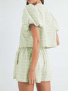 Back view showcasing the flattering fit of the light green set, with the soft puff sleeves and simple yet stylish shorts, perfect for casual outings.

