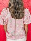 Back view of the pink puff sleeve floral blouse on model, featuring a relaxed cut and soft fabric drape.