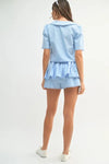  Rear view of the sky blue crop set showcasing the clean finish and soft drape of the matching pieces from the back.