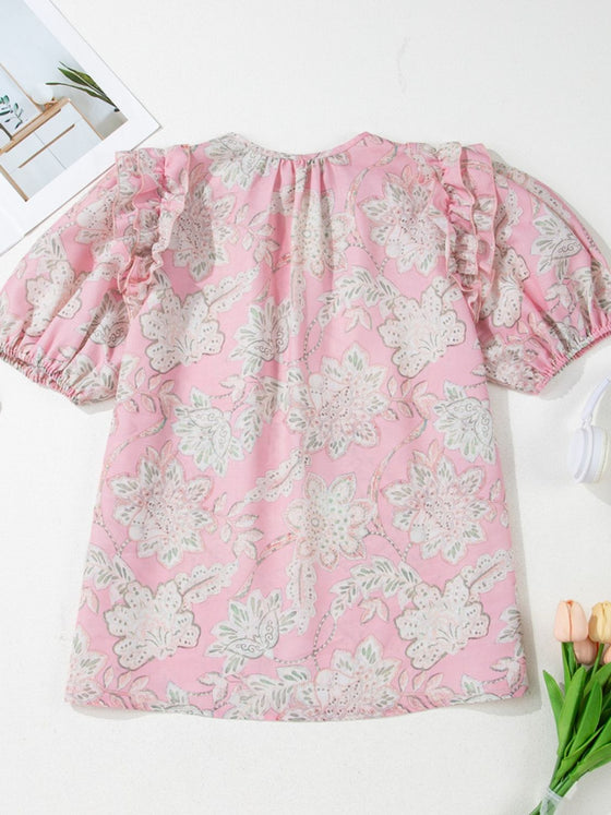 Clean backside display of the pink floral puff sleeve top, capturing the soft fabric fall and print continuity.