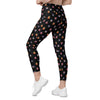 Back full pose of Cori Michelle black leggings with beetle bug print. High waist leggings with pockets for gym, yoga, or streetwear style.
