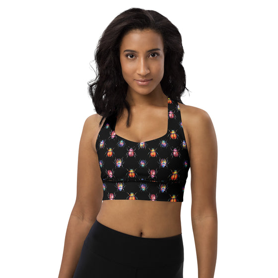 Model wearing Beetle Bug black high impact longline sports bra. Racerback design with artistic insect print, ideal for gym workouts and all-day support.