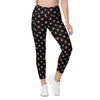 Front Angled view of beetle print compression leggings for women. Black high waisted leggings with pockets and unique insect-inspired design.
