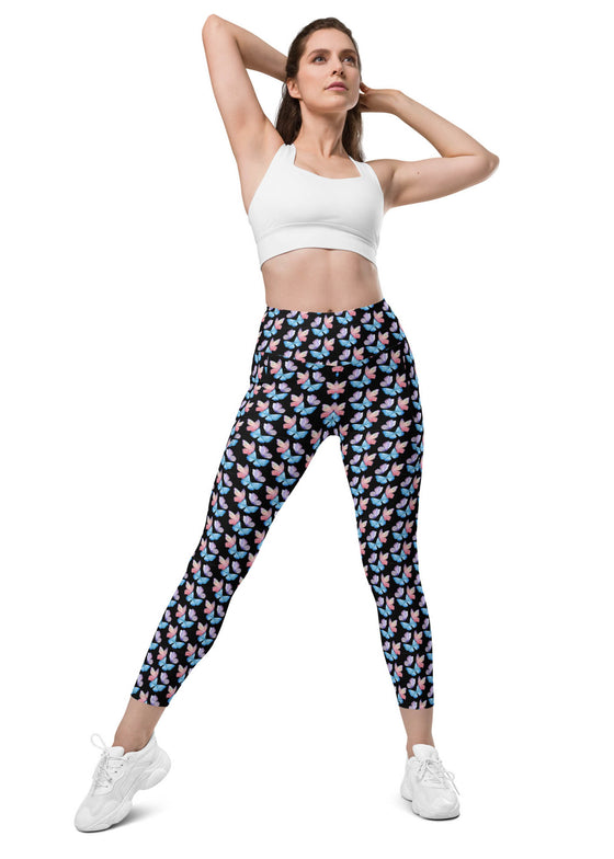 Woman wearing Black Butterfly Dreams High-Waisted Leggings with Pockets. Stylish butterfly print and high-waisted design, ideal for yoga, workouts, and casual wear.