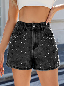  Front view of the black high-waisted denim shorts adorned with silver studs and rhinestones, showcasing the edgy yet chic design. The high waist adds structure and the detailing elevates the classic denim style.

