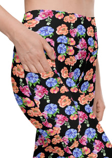  Close-up of Black Floral High Waisted Leggings with Pockets, showcasing elegant floral print and functional side pockets for added convenience during workouts or everyday use.