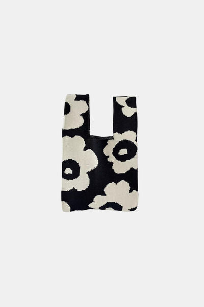 A black flower-knitted handbag with a unique flower pattern. A stylish and functional accessory to complement your everyday looks.