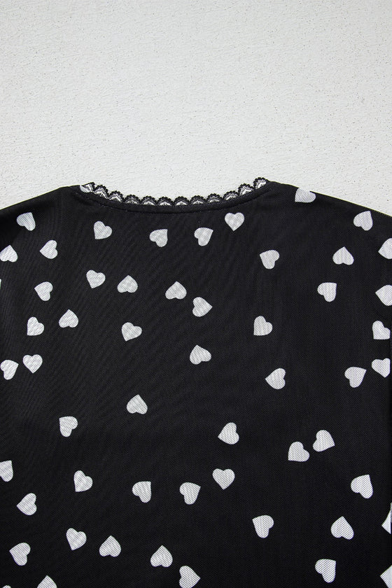 Closeup of the back neckline focusing on the keyhole-style closure, fine stitching, and delicate heart mesh overlay.


