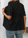  Back view of black button-down lace shirt highlighting intricate sheer fabric and minimal collar design.