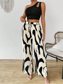  Full front view of the black one-shoulder top paired with vibrant printed pants, creating a bold and modern co-ord outfit for statement styling.