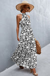Front view of black printed tie waist maxi dress with bold print and flowy cut—chic, lightweight outfit perfect for warm weather styling.