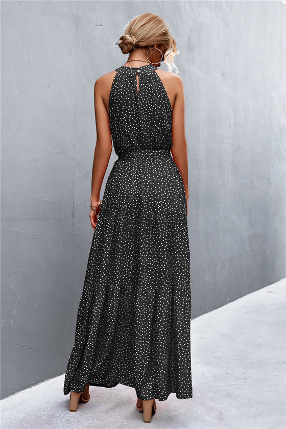 Back full view of black printed maxi dress with relaxed drape—classic sleeveless cut with lightweight feel for warm-weather wear.