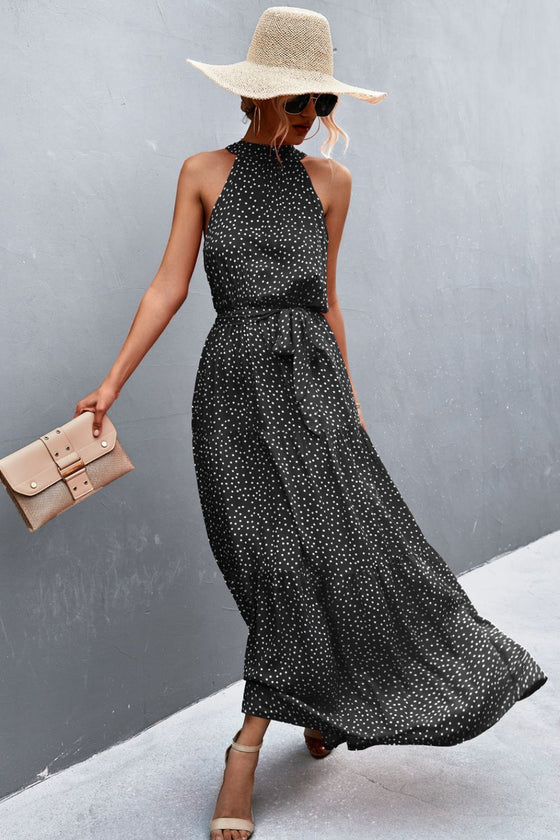 Front detail of black printed sleeveless tie waist maxi dress—comfortable and modern look for daytime events and casual elegance.