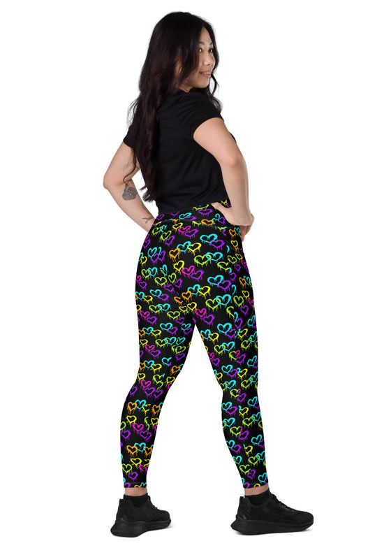 Activewear model wearing Black Rainbow Melting Hearts High-Waisted Yoga Leggings with pockets, demonstrating their stretch, compression, and stylish design for women’s fitness.