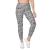 Model wearing Black & White Rosette High-Waisted Leggings with a floral print. Ideal for gym, yoga, and casual wear. Comfortable fit with side pockets.