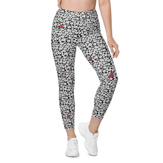 Model wearing Black & White Rosette High-Waisted Leggings with a floral print. Ideal for gym, yoga, and casual wear. Comfortable fit with side pockets.