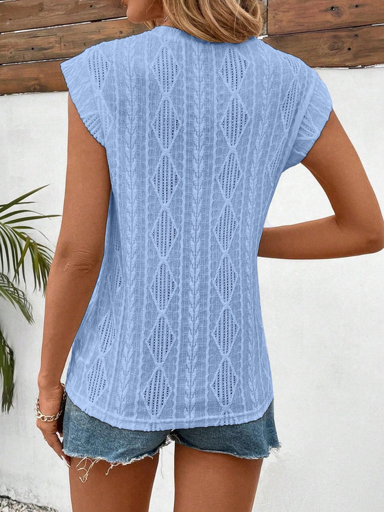Back view showcasing the subtle scallop hem and easy fit in breathable eyelet cotton material.

