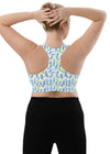 Back view of woman wearing Blue Feathers White Racerback Sports Bra. Racerback design for enhanced mobility and maximum support during intense workouts or running.