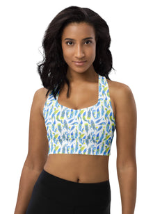  Woman wearing Blue Feathers White Racerback Sports Bra. Featuring a unique blue feather print, offering maximum support for high-impact workouts and gym sessions with a comfortable racerback design.
