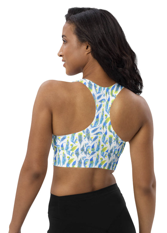 Side view of woman in Blue Feathers White Racerback Sports Bra. High sports bra support and stylish blue feather design, perfect for high-impact activities and gym sessions in larger sizes.