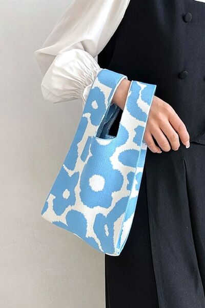 Close-up of the blue flower-knitted handbag, offering a detailed view of the blue floral pattern and fine craftsmanship.