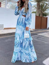 Full front of the plunge neckline and torso cutout on the blue printed dress, highlighting the ruched bodice, flattering V-neckline, and feminine floral accents on airy fabric.