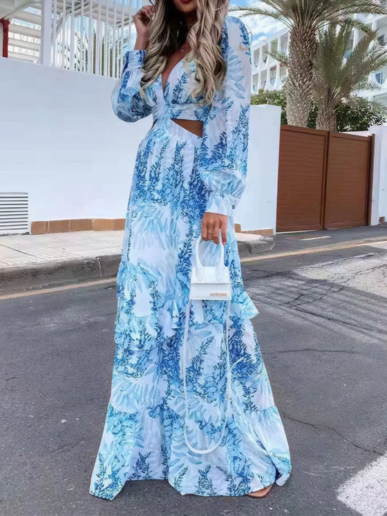 Full front of the plunge neckline and torso cutout on the blue printed dress, highlighting the ruched bodice, flattering V-neckline, and feminine floral accents on airy fabric.