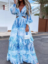 Model wearing the Blue Ruffled Printed Cutout Plunge Maxi Dress in full front view, featuring a deep plunge neckline, side cutouts, and layered ruffles flowing through the long maxi silhouette.