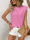 Front view of the pink blouse styled with casual pieces, showing soft cap sleeves and gentle volume.

