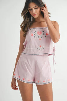  Front-facing view of the blush pink floral print co-ord set, featuring a flowy crop top with delicate flutter sleeves paired with matching soft high-waisted shorts.