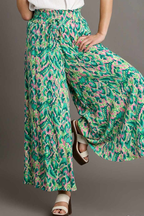 Front-facing view of the wide-leg green pants with vibrant mixed patterns, designed for movement and effortless daywear.

