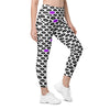 Angled view of high rise leggings featuring bold purple and black lips design. White compression leggings with pockets, blending style and performance.