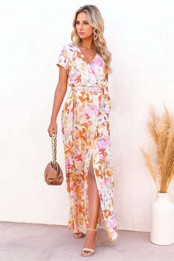 A breezy, floor-length burnt coral maxi dress with floral detailing and short sleeves, styled with a flattering tie waist for shape and comfort.

