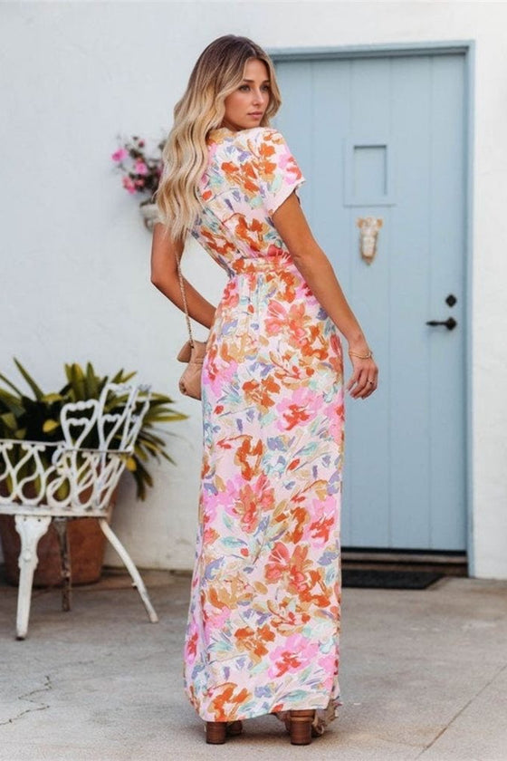 Back angle of the burnt coral short sleeve maxi dress showing the side-tie fit and soft floral print, ideal for summer wear or relaxed outings.