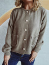 Woman wearing a button-up long sleeve cardigan with functional pockets, styled with dark jeans for a casual yet chic look.

