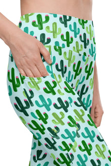  Close-up of Cactus Bloom teal high-waisted leggings with side pockets, featuring a playful cactus and lizard print for women’s activewear.