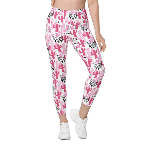 Model wearing compression leggings for women in black with pink cactus print. Back angled view showing pocket and contour design.
