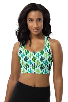  Woman wearing the Cactus Forest Teal Seamless Racerback Sports Bra. Featuring a vibrant teal cactus print, seamless fit, and high-impact support for gym workouts and running.
