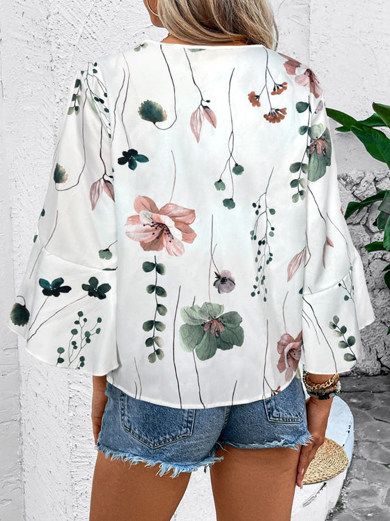 Woman modeling the back of a lightweight, printed white half sleeve blouse, perfect for summer or casual wear.