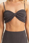 Close-up front view of the Charcoal Bra Top and Mini Skirt Set, focusing on the details of the design and the fabric texture.