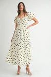  Full front view of cream midi dress with puff sleeves and all-over dot print, offering a refined and feminine look.