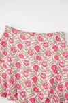 Close-up shots of the mini skirt showcasing the floral print detailing and soft flowing fabric, emphasizing the texture and lightness that make it ideal for summer wear.

